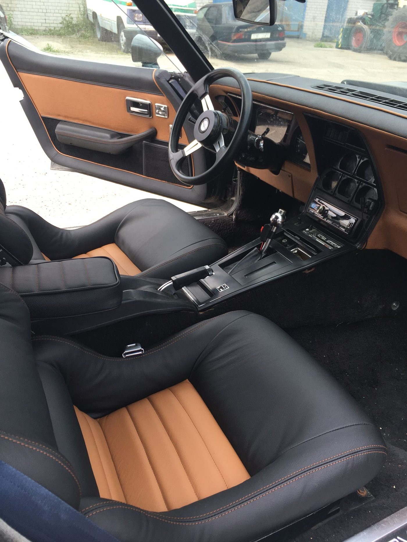 Corvette C3 salong: musta ja konjakipruuni nahaga istmed, oranž kontrastõmblus.